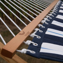 Load image into Gallery viewer, Close-up of the Vivere wooden spreader bar, white suspension ropes and metal eyelets on the Harbour hammock.