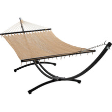 Load image into Gallery viewer, Tan Caribbean polyester rope hammock with dark spreader bars on a black 12ft steel arc stand