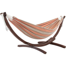 Load image into Gallery viewer, Cameo coral and beige striped double Sunbrella® hammock on a curved solid pine stand against a white background.
