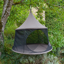 Load image into Gallery viewer, Taupe Cacoon Reto hanging among leafy trees, with its circular entrance open.
