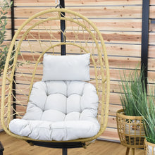 Load image into Gallery viewer, Close-up of the Nest Chair’s beige tufted seat cushion, pillow and woven webbing