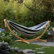 Load image into Gallery viewer, Harbour striped cotton hammock on a pine arc stand in a garden beside a pond