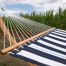Load image into Gallery viewer, Harbour hammock showing its wooden spreader bar and white suspension ropes attached to a timber post outdoors.