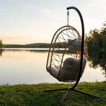 Load image into Gallery viewer, Rear view of the Cappuccino Deluxe Nest Chair and curved steel stand beside a lake at sunset.