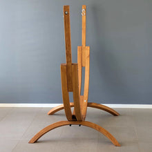 Load image into Gallery viewer, Side view of the Coastal Lounger timber stand showing its twin curved wooden rails and wide support feet