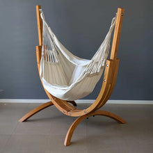 Load image into Gallery viewer, Angled view of the Luxury Natural cream hanging chair suspended from the Coastal Lounger timber stand