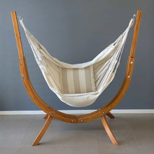 Load image into Gallery viewer, Front view of the Coastal Lounger timber stand with a cream hanging chair and striped cushio