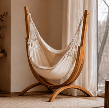 Load image into Gallery viewer, Coastal Lounger timber stand with a cream hanging chair beside a curtained window