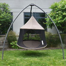 Load image into Gallery viewer, Front view of a Taupe Cacoon Reto hanging from a grey tripod stand on a lawn.