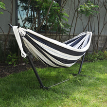 Load image into Gallery viewer, Black and white striped hammock on a stand in a garden setting